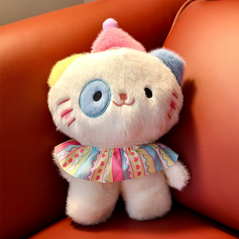 The ZoDoll Adorable 8.7" Cute Cat Plush Toy, a soft kawaii kitten stuffed animal with random eye color, sits on an orange sofa, dressed in a colorful ruffled collar and tiny hat.