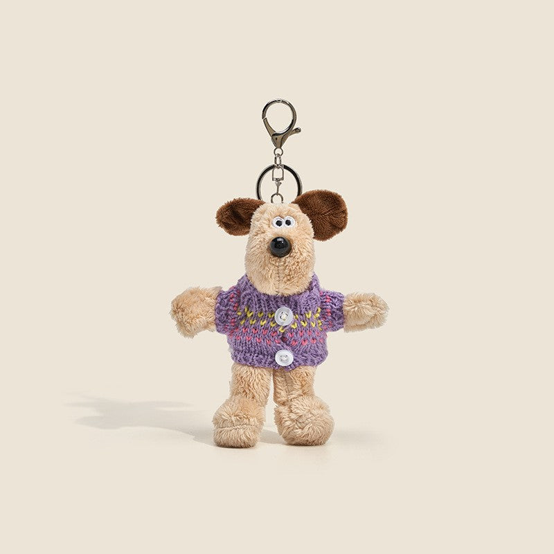 Long-fur cream dog plush charm wearing purple knitted sweater with button details