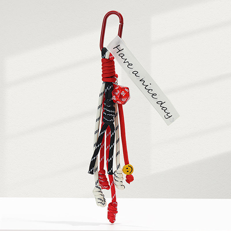 Red carabiner braided rope keychain charm with red, black, and white cord strands and printed fabric tag