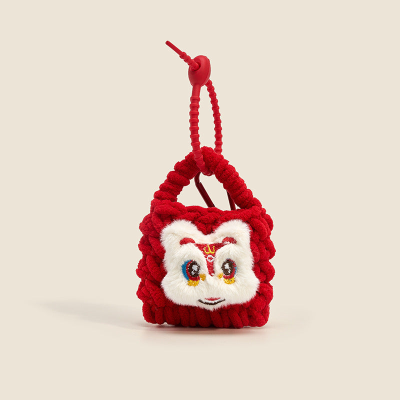 Red chunky-knit mini bag charm with lion face applique and red coiled lanyard clip