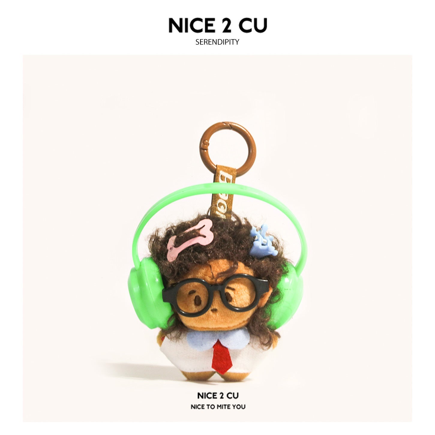 Kawaii plush keychain with brown hair, black glasses, and bright green over-ear headphones