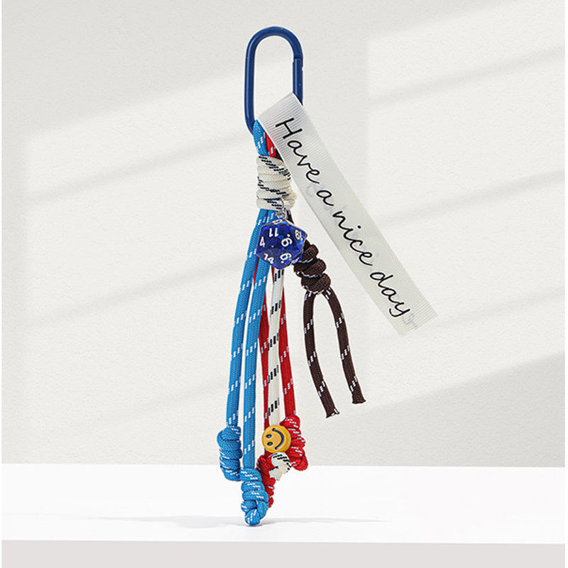 Blue carabiner braided rope bag charm keychain with dice bead, smiley bead, and Have a nice day fabric tag