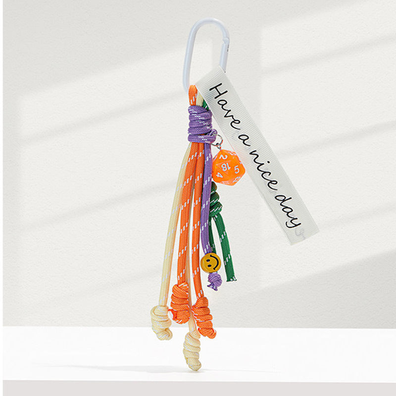 White carabiner bag charm keychain with candy-colored orange, purple, green, and yellow braided rope strands