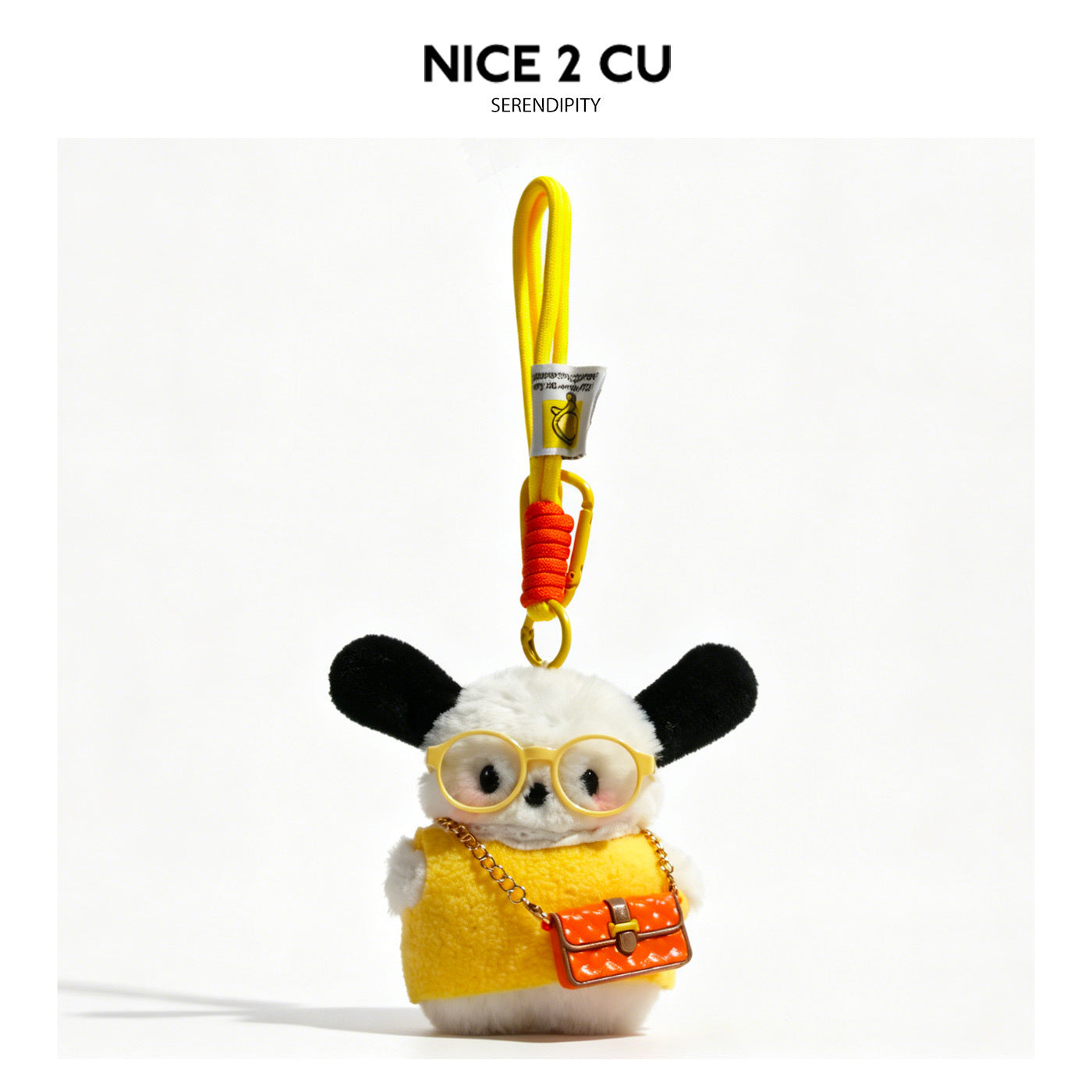 Plush dog bag charm in yellow outfit with round yellow glasses and orange-pink miniature handbag on yellow clip cord