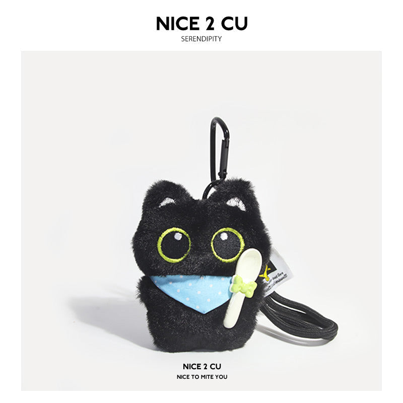 Black cat plush charm wearing a light blue polka-dot triangular bib and holding a white spoon