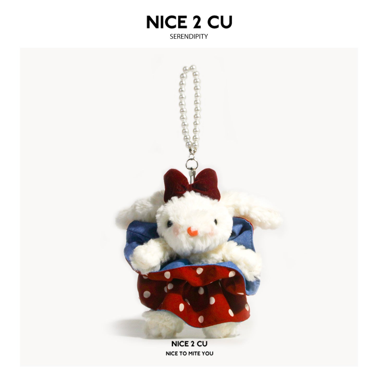 Kawaii white lop-eared rabbit plush keychain wearing a denim top, red polka-dot skirt, and large burgundy bow, with silver ba