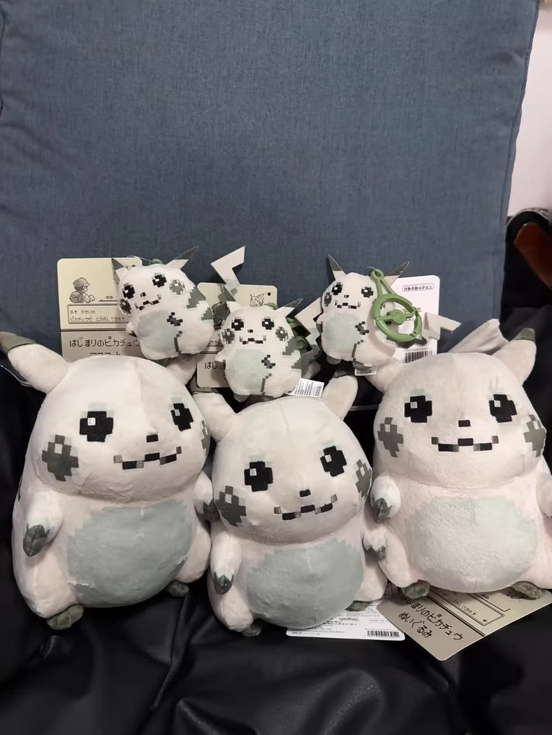 Several ZoDoll Retro 8-Bit Pikachu of Beginnings Plush – Classic Chunky Pokémon 30th Anniversary Pikachu toys, including large plushies and small keychain versions, are displayed in front of a big blue cushion.