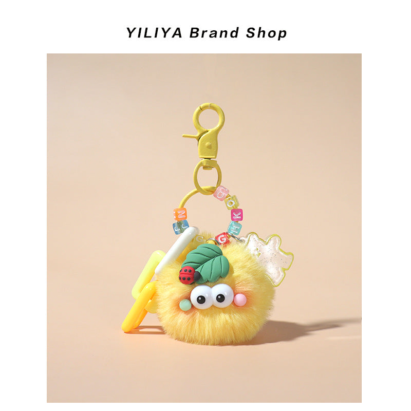 Yellow fluffy pom-pom charm with yellow small clip hardware, pastel beads, geometric plastic accents, and ladybug leaf topper