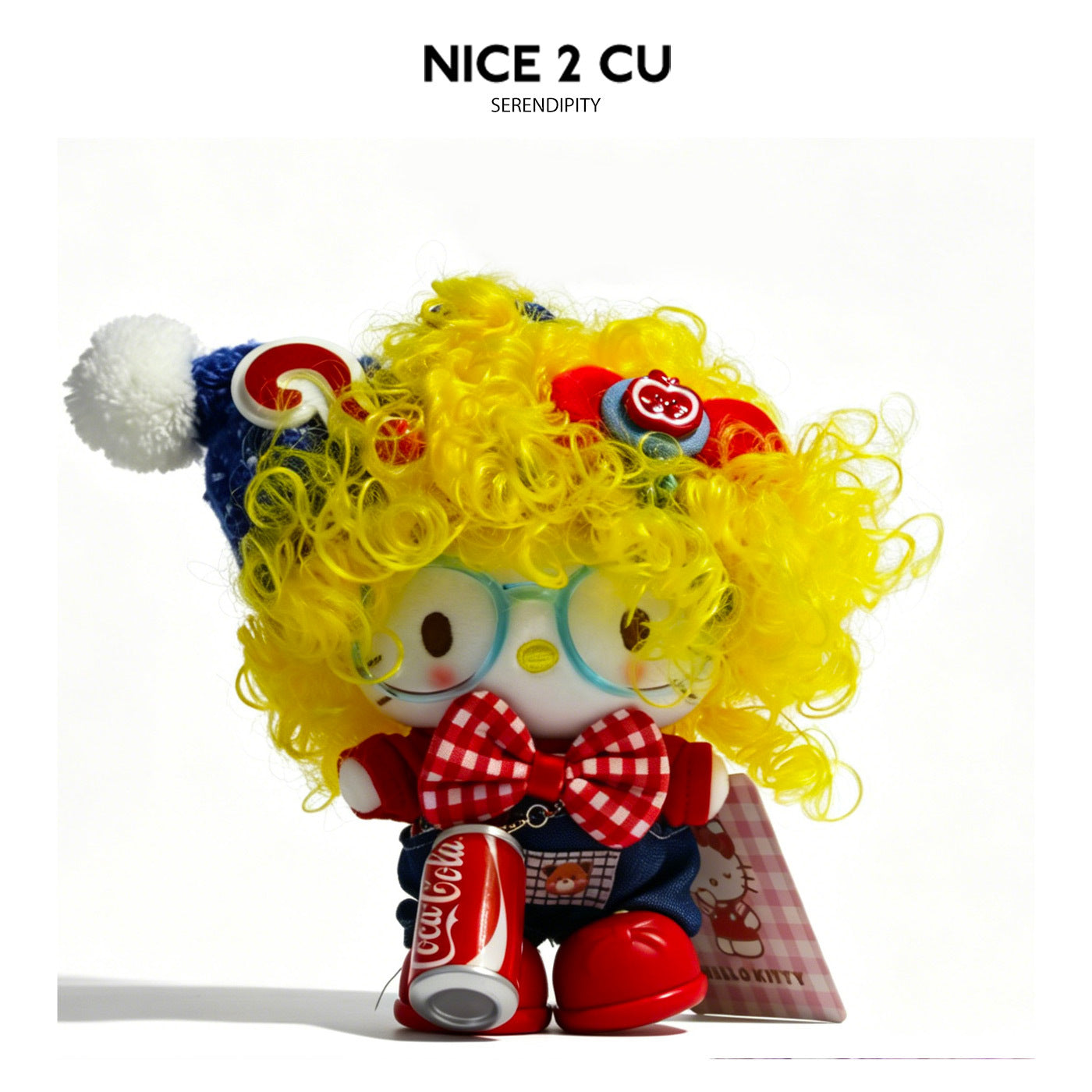 Hello Kitty plush charm with bright yellow curly hair, blue hat, red bow tie, and small can accessory