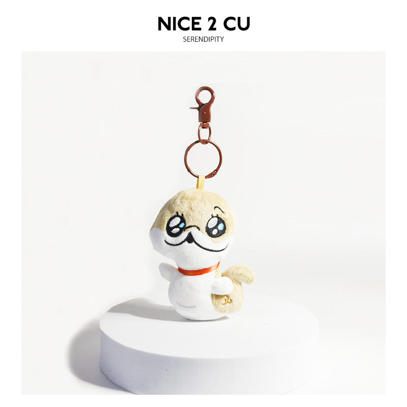 Cartoon dog plush keychain charm with pitiful pleading eyes, cream and white body, and gold-tone split ring