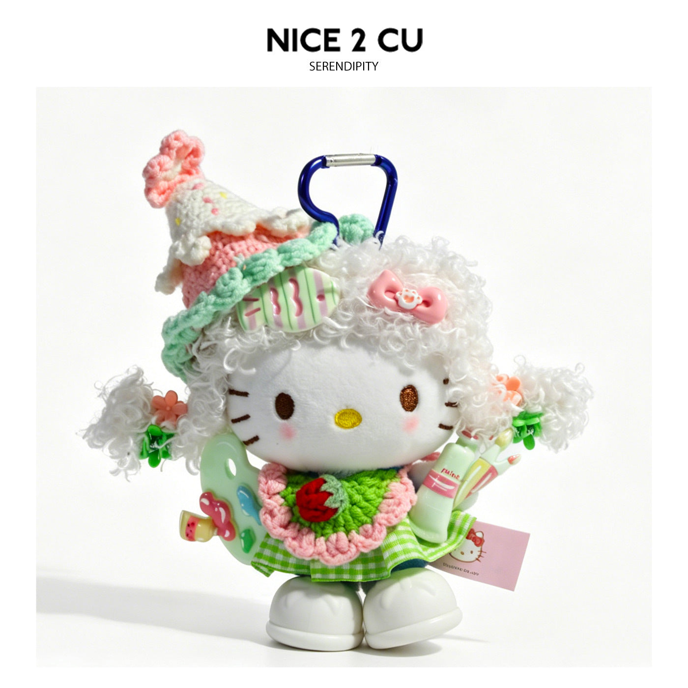 Kawaii cat plush bag charm dressed as an artist with curly white crochet hair, green gingham outfit, and miniature paint pale