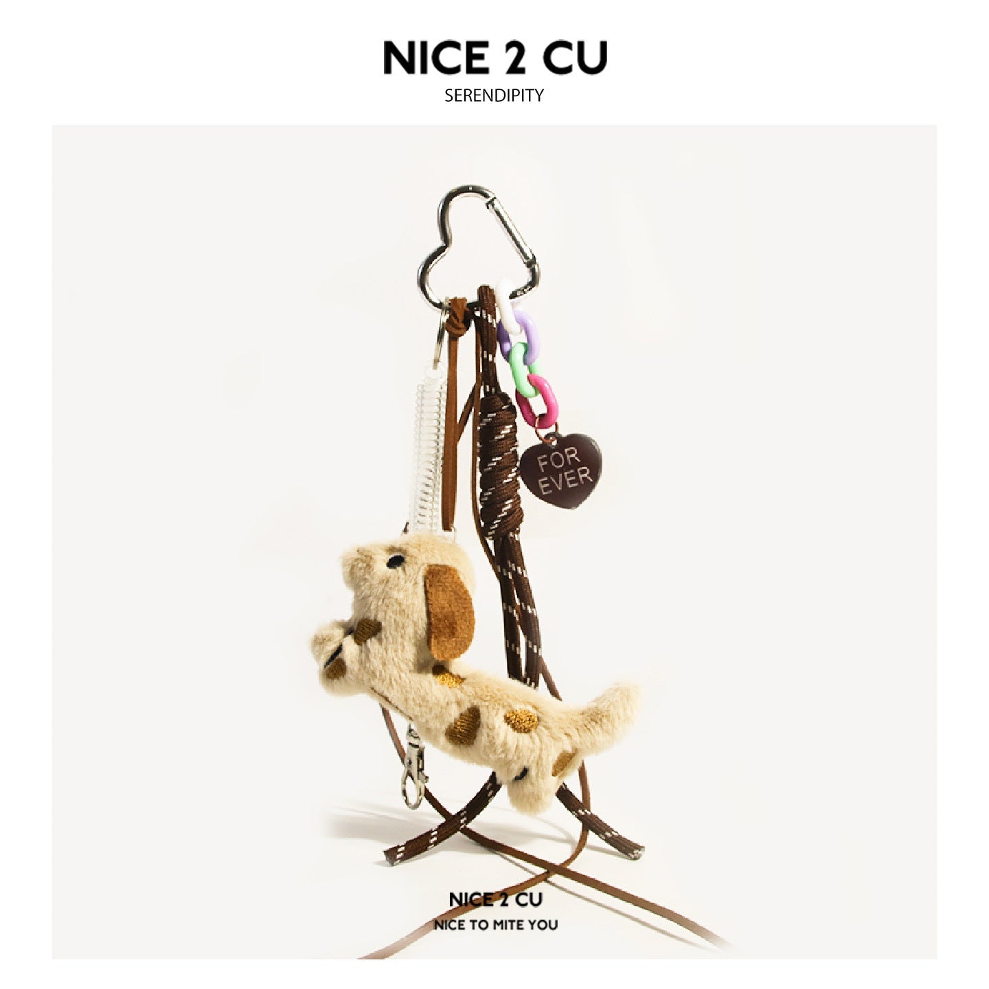 Cream spotted plush dog with brown ears and brown heart tag reading FOR EVER on brown cords with silver heart clasp