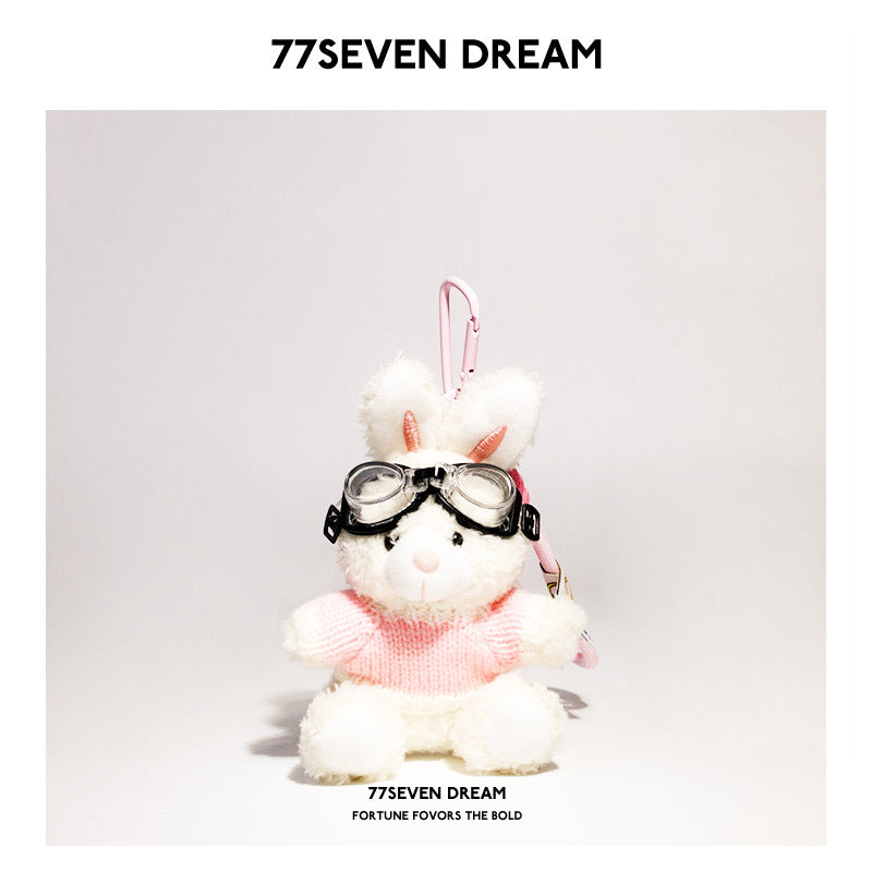 White rabbit plush keychain wearing pink-and-white knit sweater and goggles with pink hanging clip