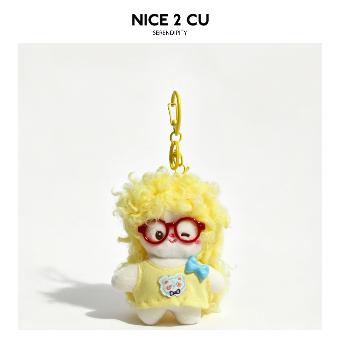 Yellow curly-haired kawaii bunny plush keychain charm with red glasses and yellow outfit with blue bow
