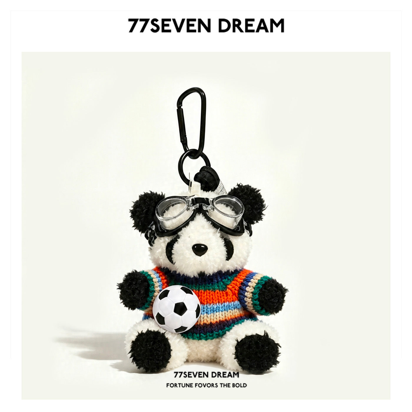 Shaggy panda plush keychain wearing a multicolor striped knit sweater with goggles and soccer ball, carabiner clip