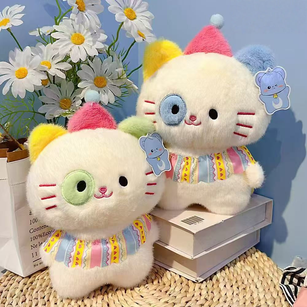 Two ZoDoll Adorable 8.7" Cute Cat Plush Toys with colorful ears and collars sit on books among daisies. Each soft Kawaii kitten has a bear-shaped tag, and one features a blue patch over its eye (eye color is random).