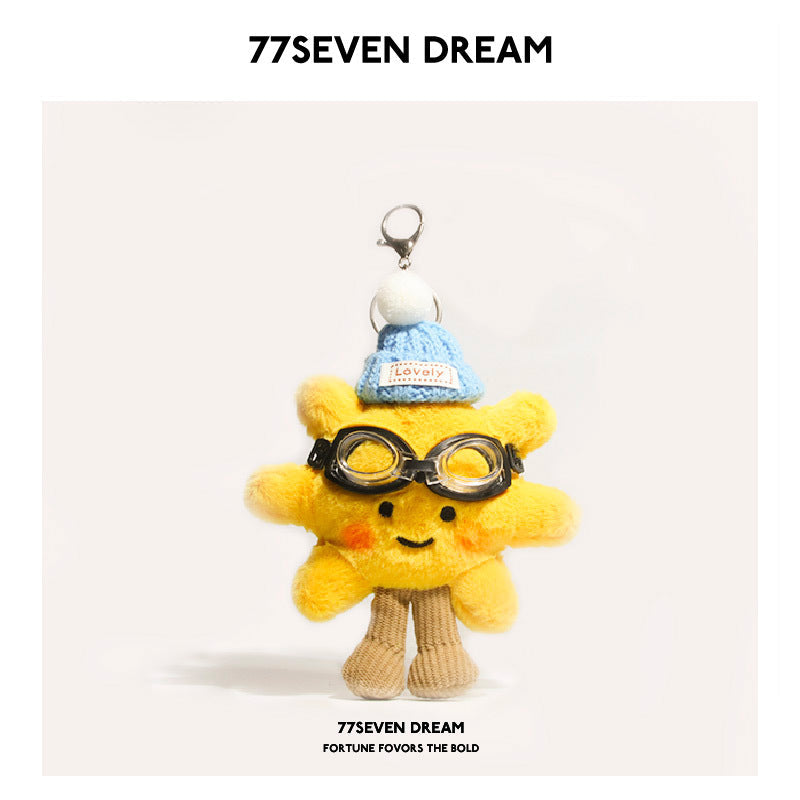 Yellow sunflower plush charm with light blue knit hat and black toy goggles