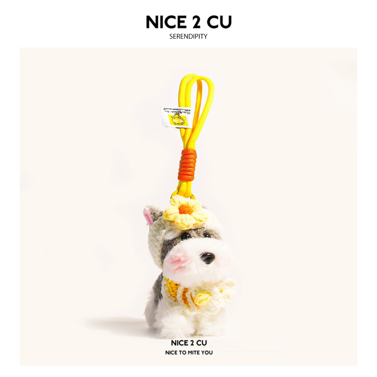 Schnauzer plush pendant with yellow flower decorations on head and chest, yellow hanging cord with orange wrap