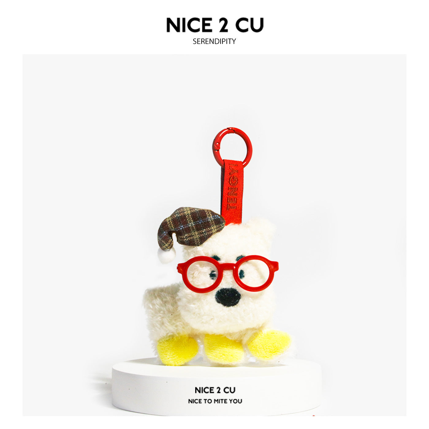 White fluffy plush dog keychain charm wearing a brown plaid hat with pompom and red round-frame glasses, attached with a red 