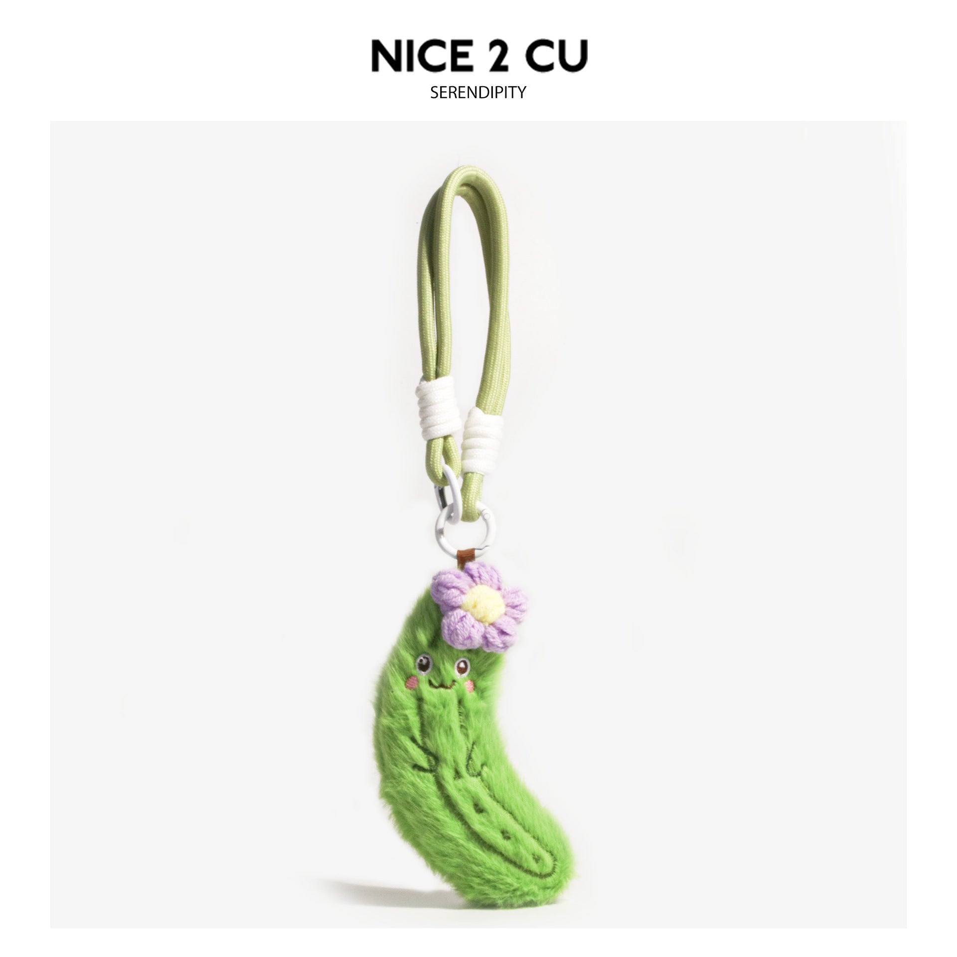 Green cucumber plush keychain charm with purple flower accent and light green loop cord