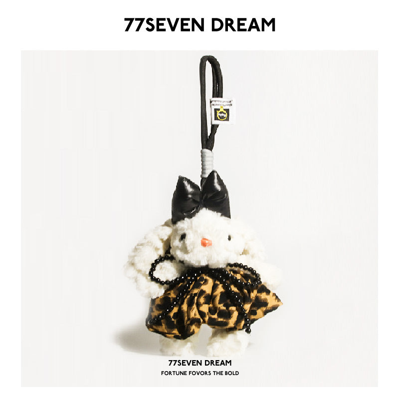 White bunny plush keychain charm with black bow and brown leopard-print skirt with black bead trim