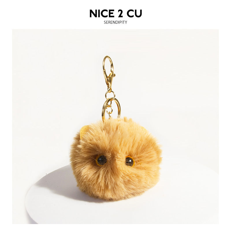 Khaki golden-brown fluffy round cat face keychain charm with gold-tone clip hardware on white display