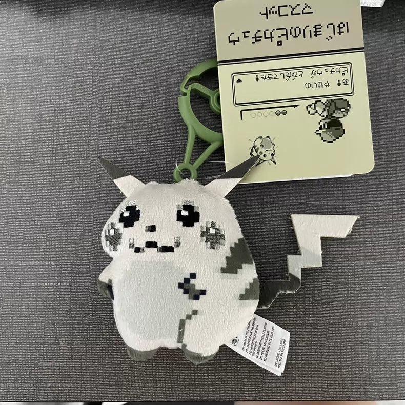The ZoDoll Retro 8-Bit Pikachu of Beginnings Plush Bag Clip is a 12cm keychain featuring classic chunky Pokémon 30th Anniversary Pikachu with a green clip, shown on a gray surface with an attached pixel art card.