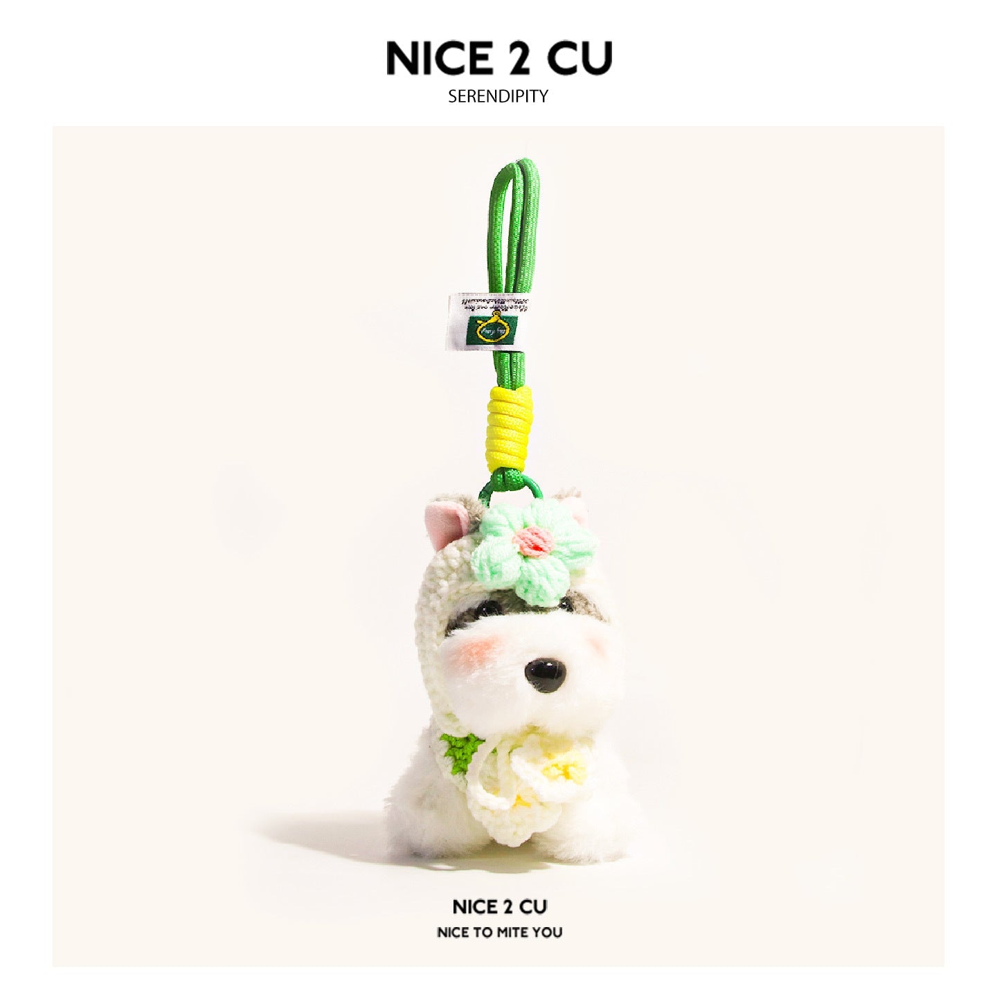 Schnauzer plush bag charm with green flower decoration on head and chest, bright green hanging cord with yellow wrap