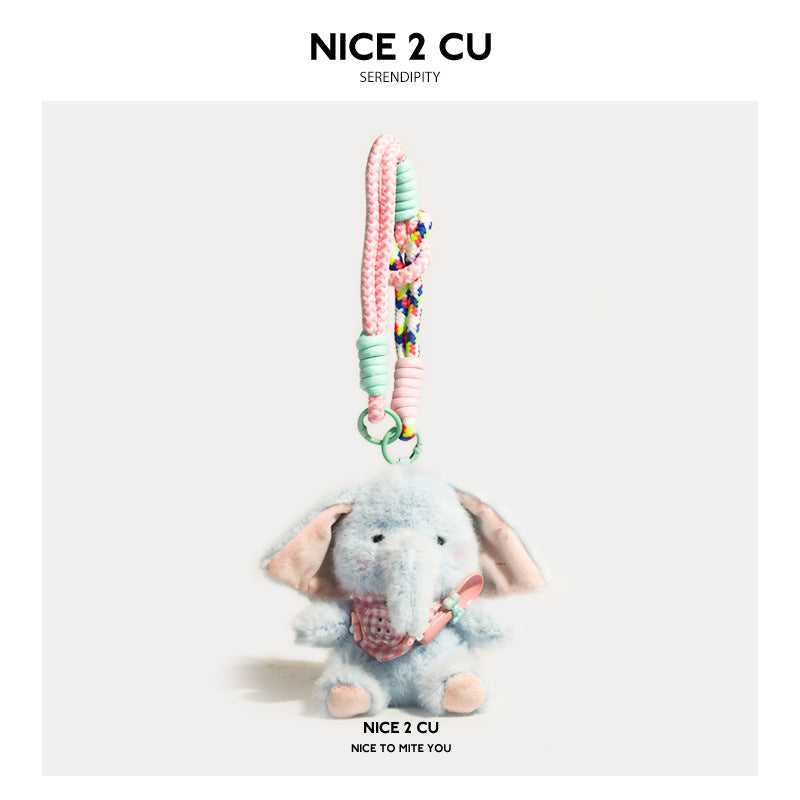 Light blue plush elephant charm wearing a pink apple-pattern bib on a pastel braided strap