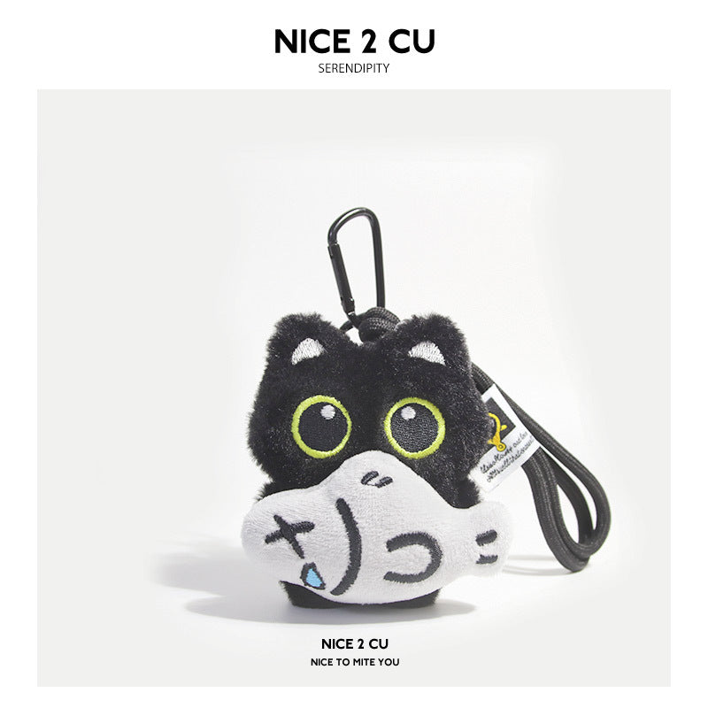 Black cat plush keychain holding a gray fish-shaped accessory with carabiner clip