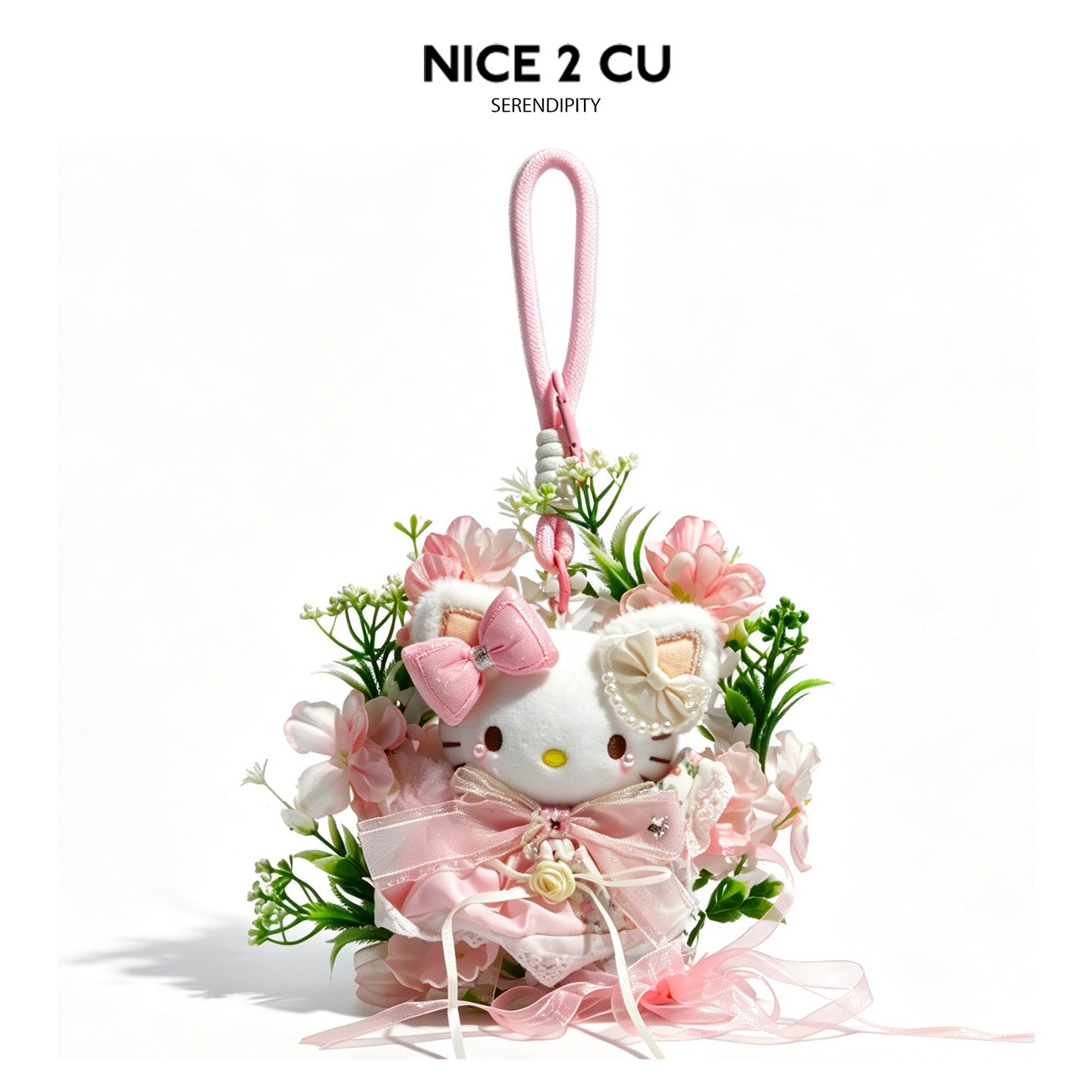 Pink kawaii cat plush hanging charm with faux cherry-blossom floral wreath, lace collar, satin bow, and trailing ribbon strea