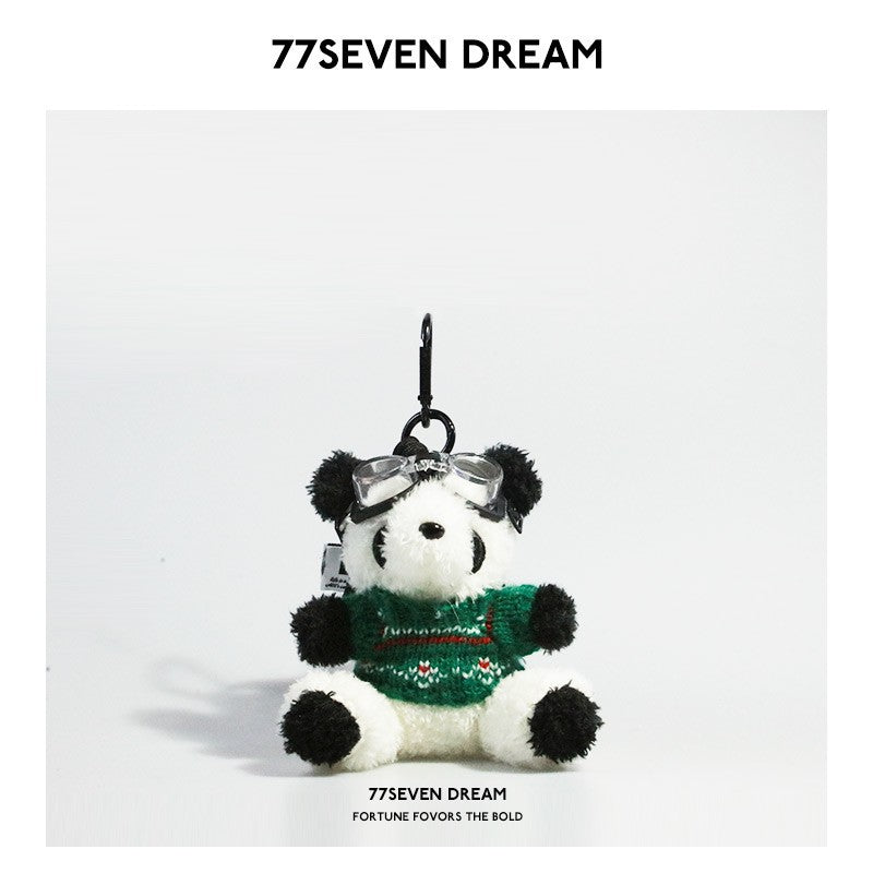 Panda keychain charm wearing green knitted sweater with white pattern details and clear goggles