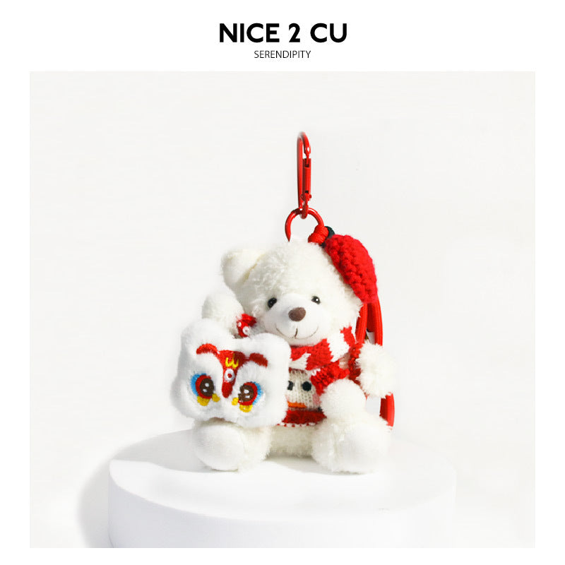 White plush bear keychain charm with red hat and lion dance motif panel attached to red carabiner clip