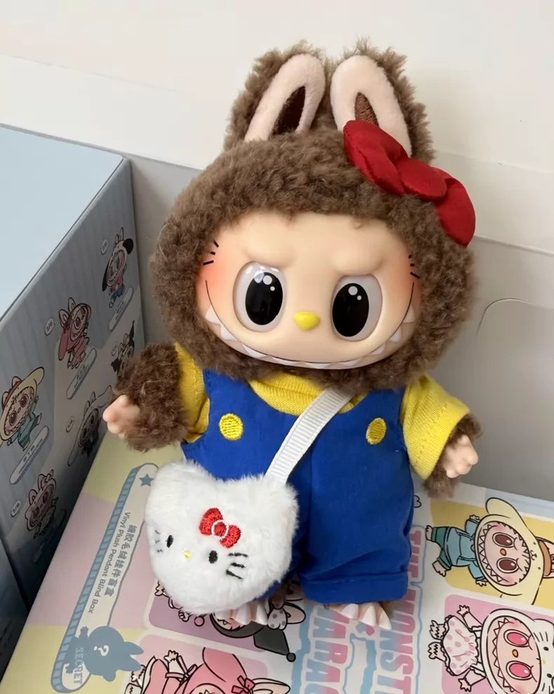 The POP MART LABUBU Hello Kitty and Friends Series Secret Edition Plush Pendant Figure features large cartoon eyes, a brown bunny hood with red bow, a yellow and blue outfit, and a Hello Kitty purse, standing atop a colorful box.