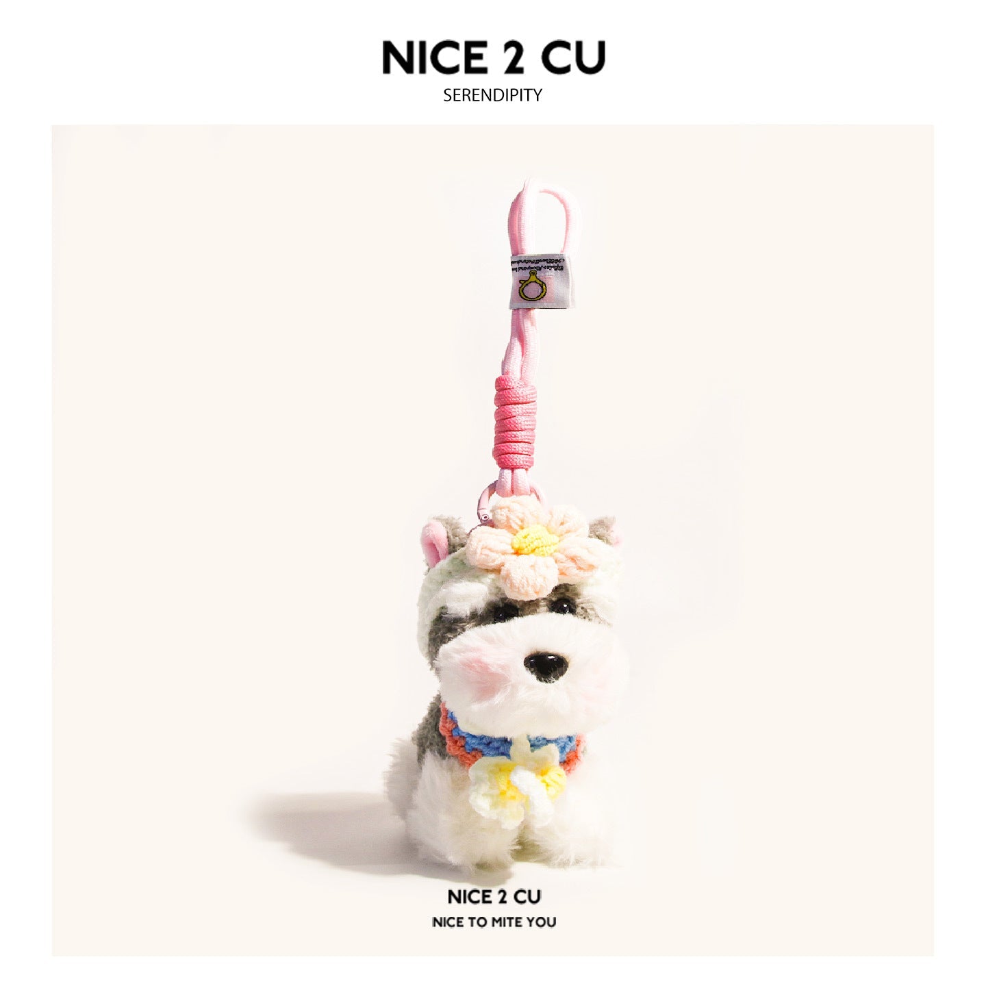 Schnauzer plush keychain charm with soft pink flower accents on head and chest, pink hanging cord