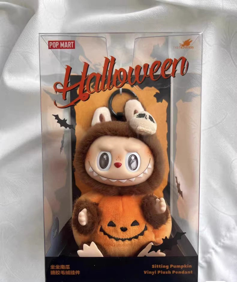 The POP MART THE MONSTERS – Happy Halloween Party Labubu 15cm Vinyl Plush Keychain (Pumpkin Edition) features Labubu in a pumpkin costume with bunny ears, packaged festively for Halloween.