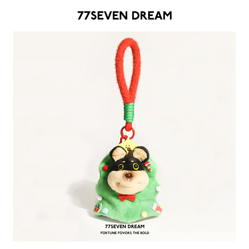 Plush dog charm dressed in a green Christmas tree costume with ornament details