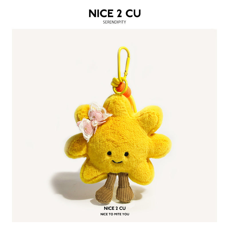 Yellow sunflower plush charm decorated with a pink bow with lace trim and pearl-like accent