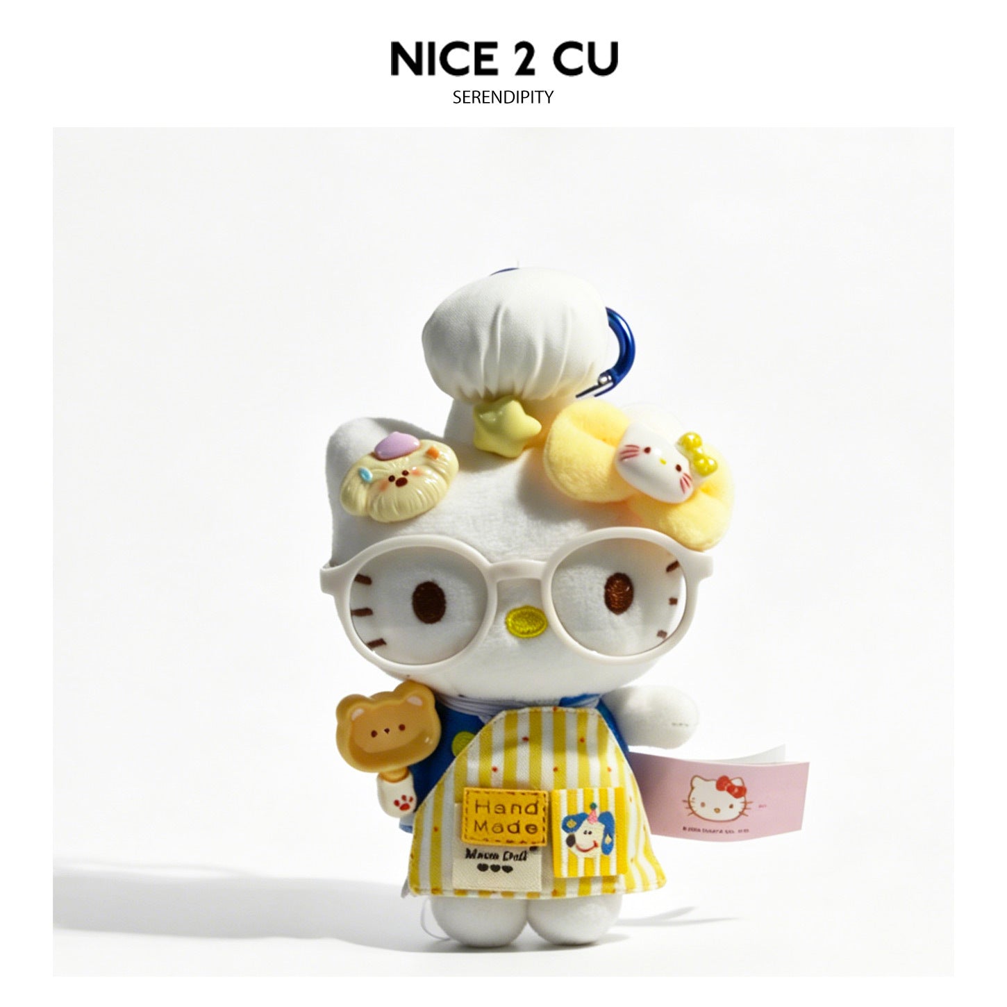 White cat plush charm in cream frilly dress with yellow bow accent and straw hat