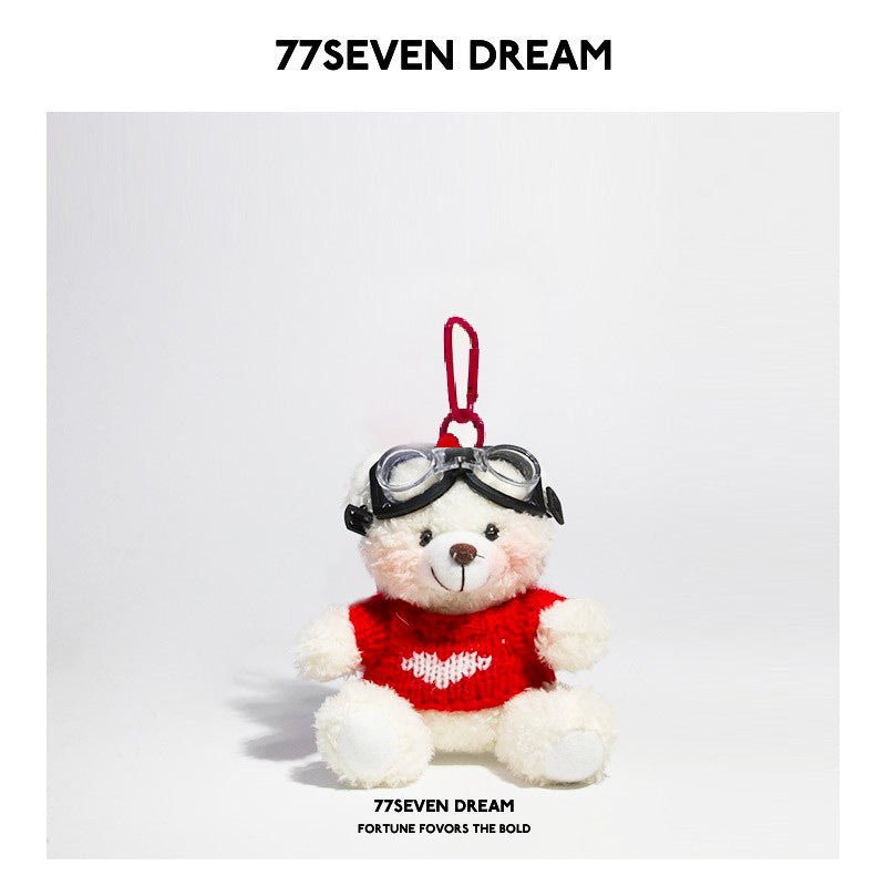 White bear plush keychain wearing red heart knit sweater and goggles with red hanging clip