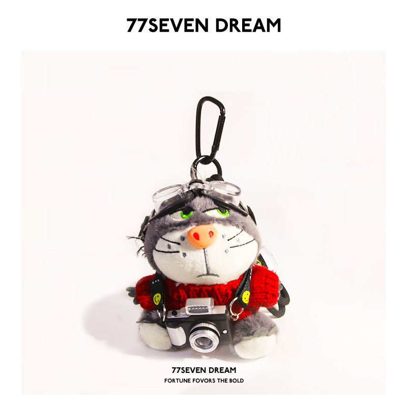 Plush cat charm with goggles and mini camera in red knitted outfit and black carabiner clip