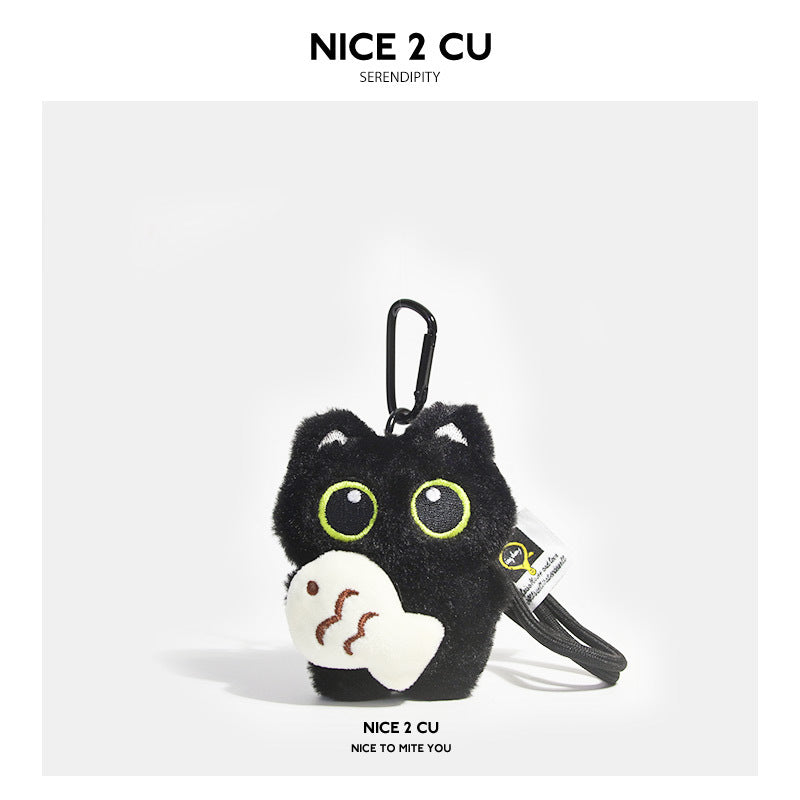 Black cat plush keychain holding a small white fish with brown line detail markings