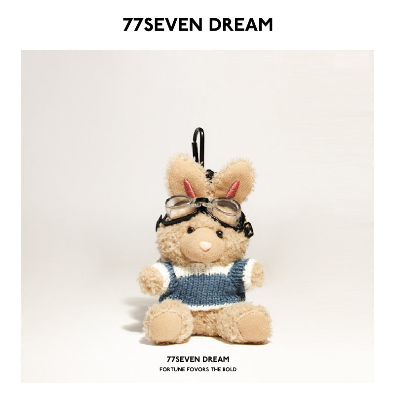 Tan rabbit plush keychain wearing blue-and-white knit sweater and goggles with black hanging clip