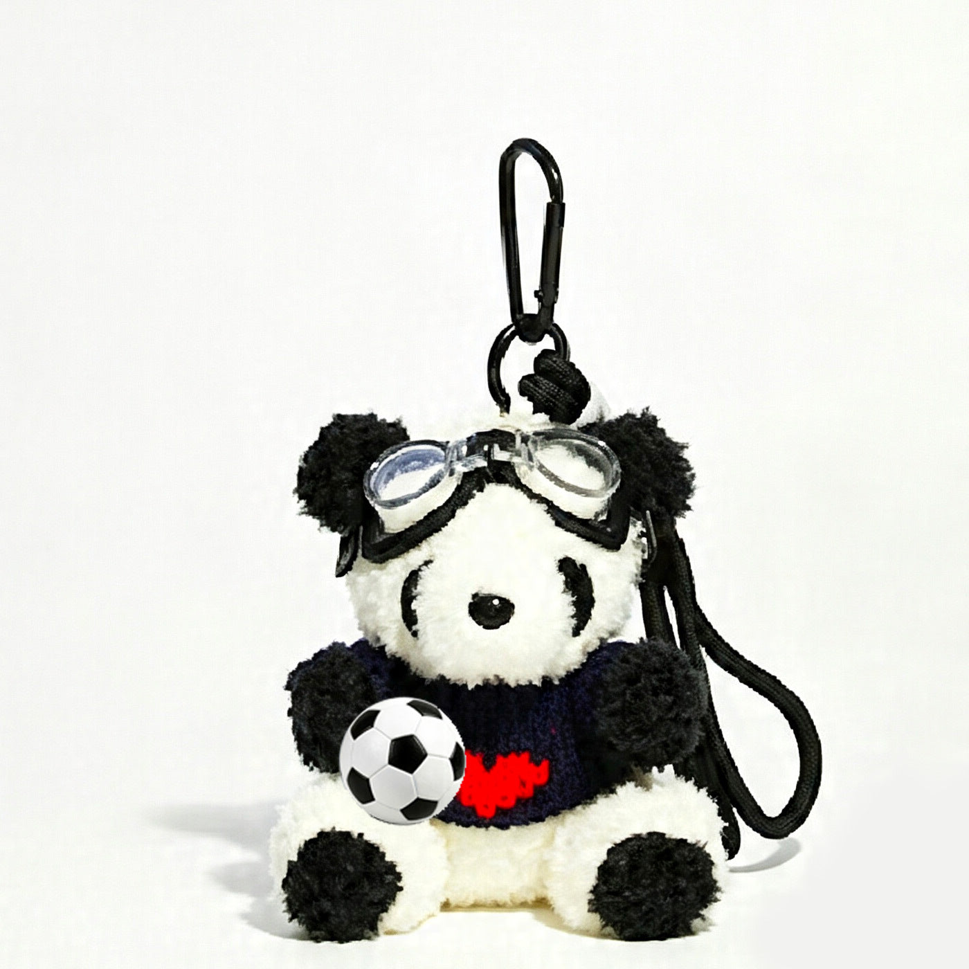 Panda plush keychain in a dark navy and black knit sweater with a red heart motif, holding a soccer ball