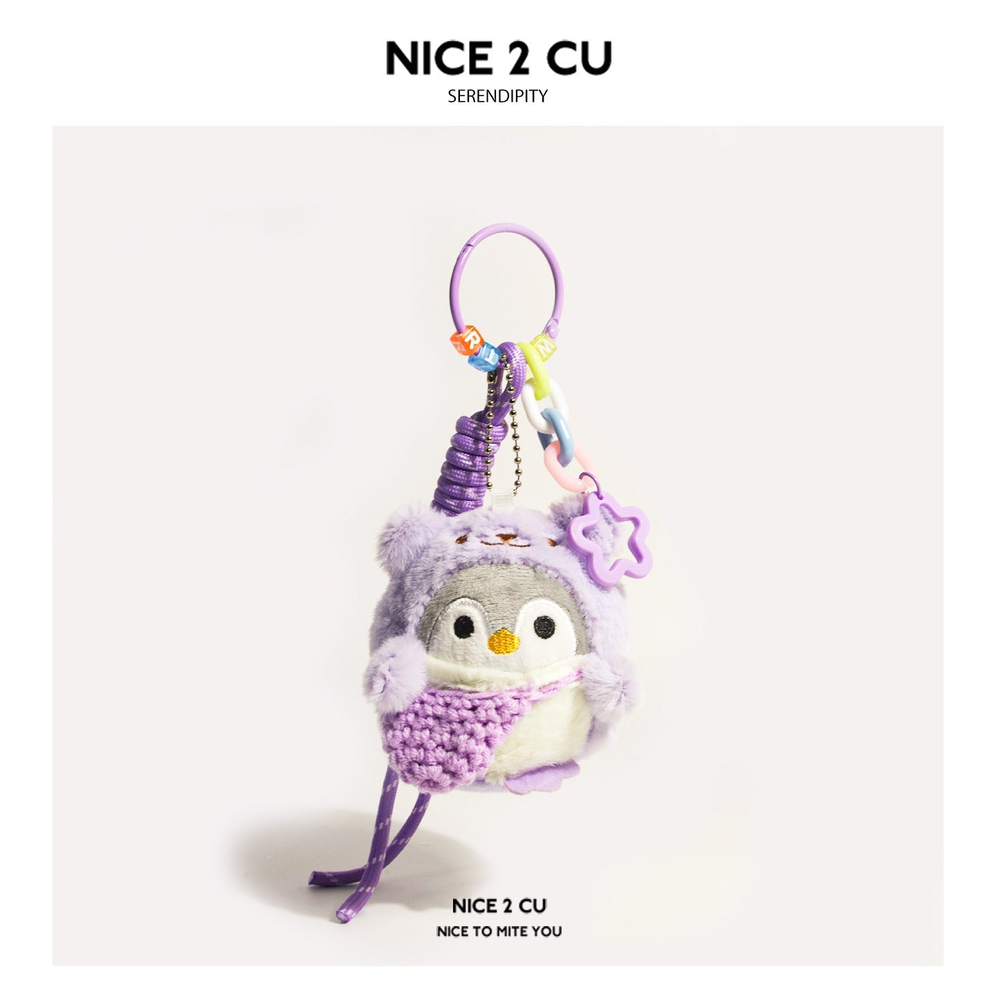 Purple plush penguin bag charm with star-shaped pendant and braided purple cord