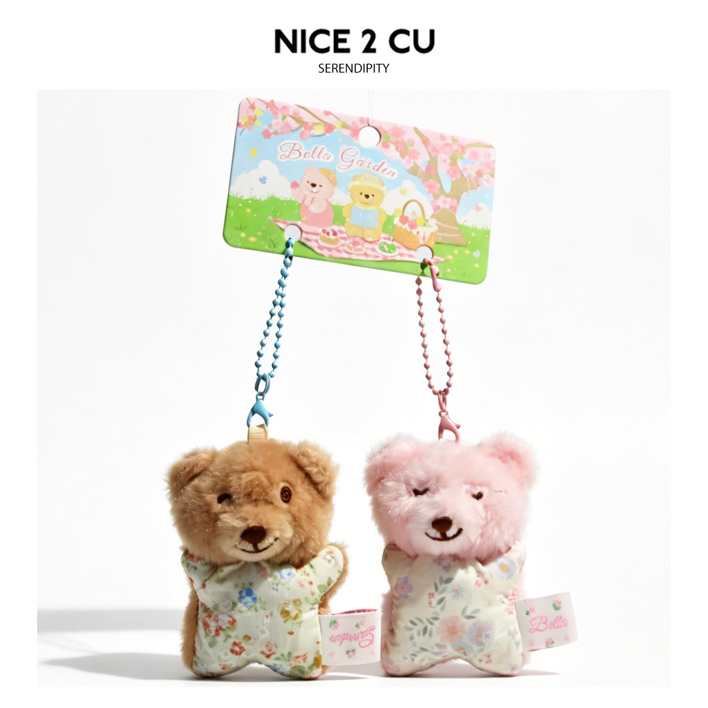 Two small plush teddy bear charms in brown and pink hanging from a Bello Garden printed card with bead cords