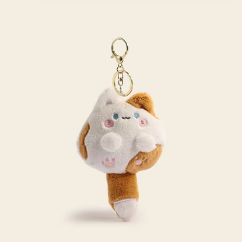 Chubby kawaii plush cat keychain in white and golden-brown with embroidered sleepy eyes and pink cheeks