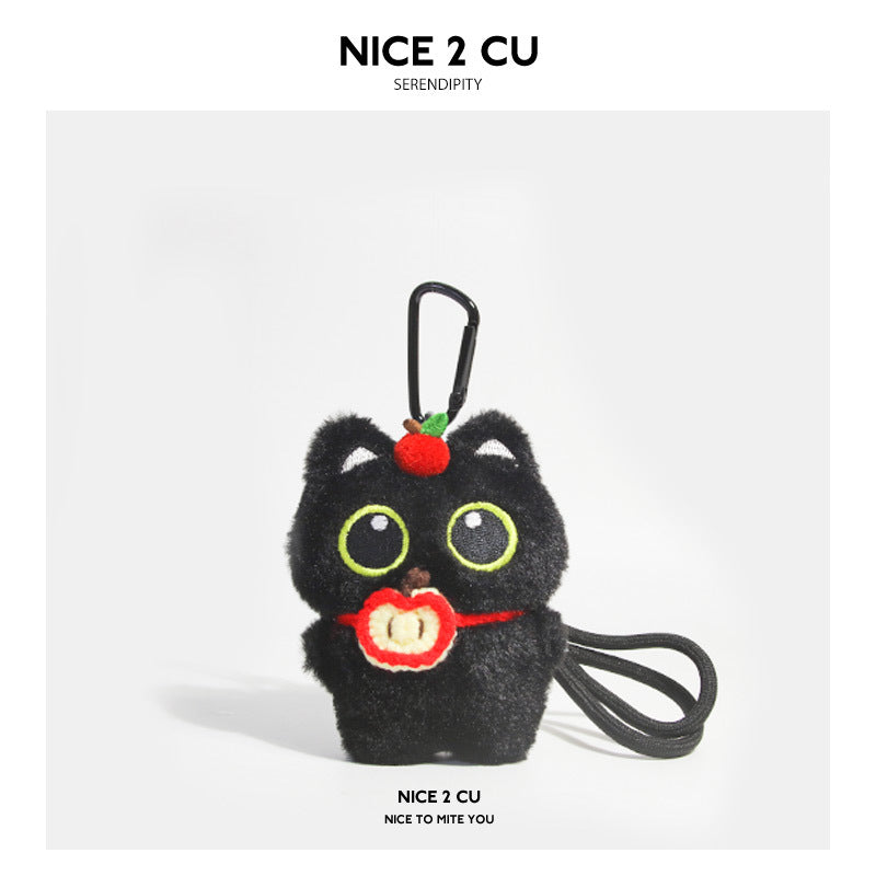 Black cat plush keychain with red apple-themed accessories on head and front