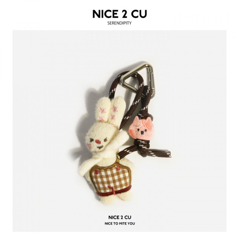 Cream plush rabbit keychain charm in brown gingham outfit with braided cord and silver clip