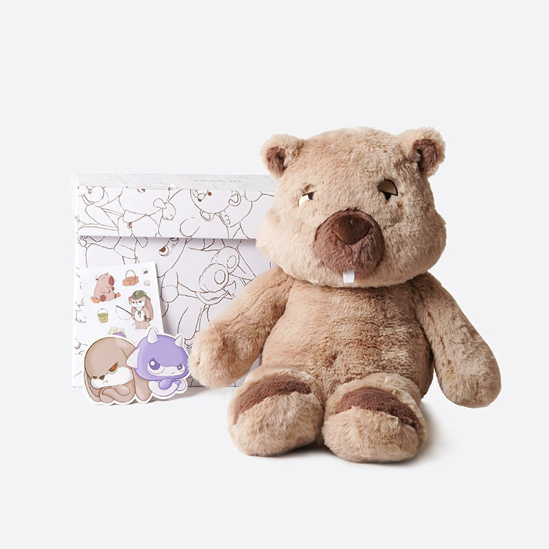 A ZEIO Wombat Plush Toy (48cm) sits before a white gift box with line art, joined by two illustrated character stickers—an ultra-soft stuffed animal with a mini doll, ideal for cuddling or gifting.